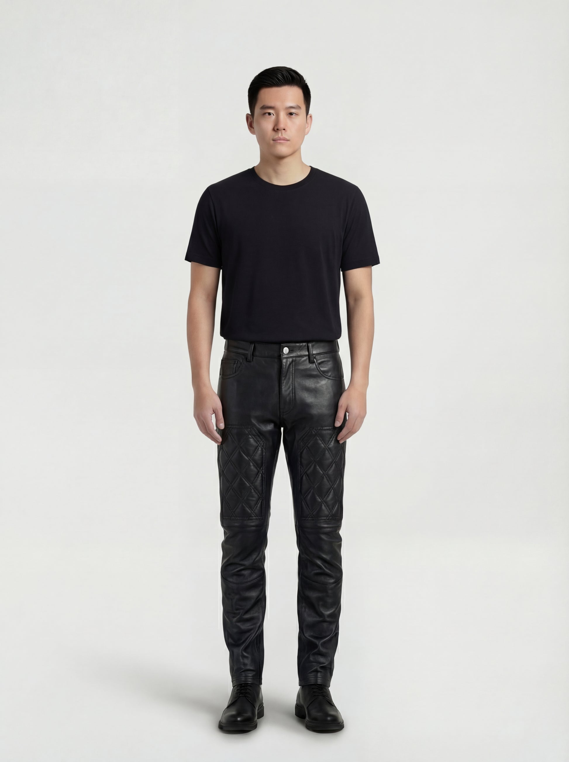 Male model wearing Maverick Jett quilted leather moto pants, slim fit, styled with black crew neck t-shirt and black leather derby shoes. Maverick Jacket.