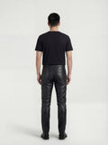 Rear view of male model wearing Maverick Jett quilted leather moto pants showing fitted seat silhouette and straight leg cut. Maverick Jacket.