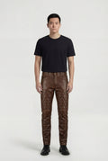 Male model wearing Maverick Nolan quilted leather pants, slim fit, styled with black crew neck t-shirt and black leather derby shoes. Maverick Jacket.