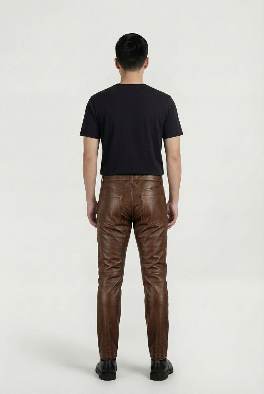Rear view of male model wearing Maverick Nolan quilted leather pants showing fitted seat silhouette and rear pocket styling. Maverick Jacket.