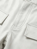 Macro shot of white pebbled leather texture and heavy-duty stitching detail on cargo pants. The Cassian by Maverick Jacket.