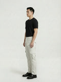 Side profile of Maverick Cassian leather cargo pants showing dimensional cargo pocket structure and straight leg cut. Maverick Jacket.