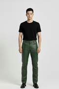 Male model wearing Maverick Finnian forest green leather pants, straight fit, styled with black crew neck t-shirt and black leather boots. Maverick Jacket.