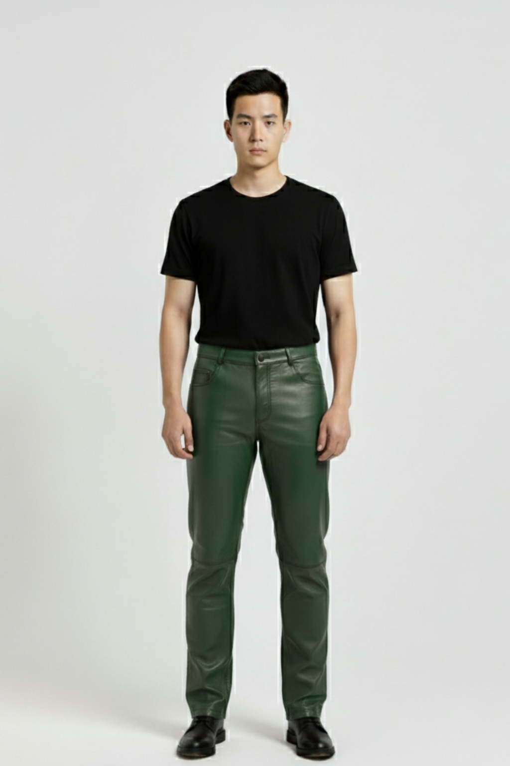 Male model wearing Maverick Finnian forest green leather pants, straight fit, styled with black crew neck t-shirt and black leather boots. Maverick Jacket.