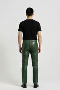 Rear view of male model wearing Maverick Finnian forest green leather pants showing fitted seat silhouette and straight leg cut. Maverick Jacket.