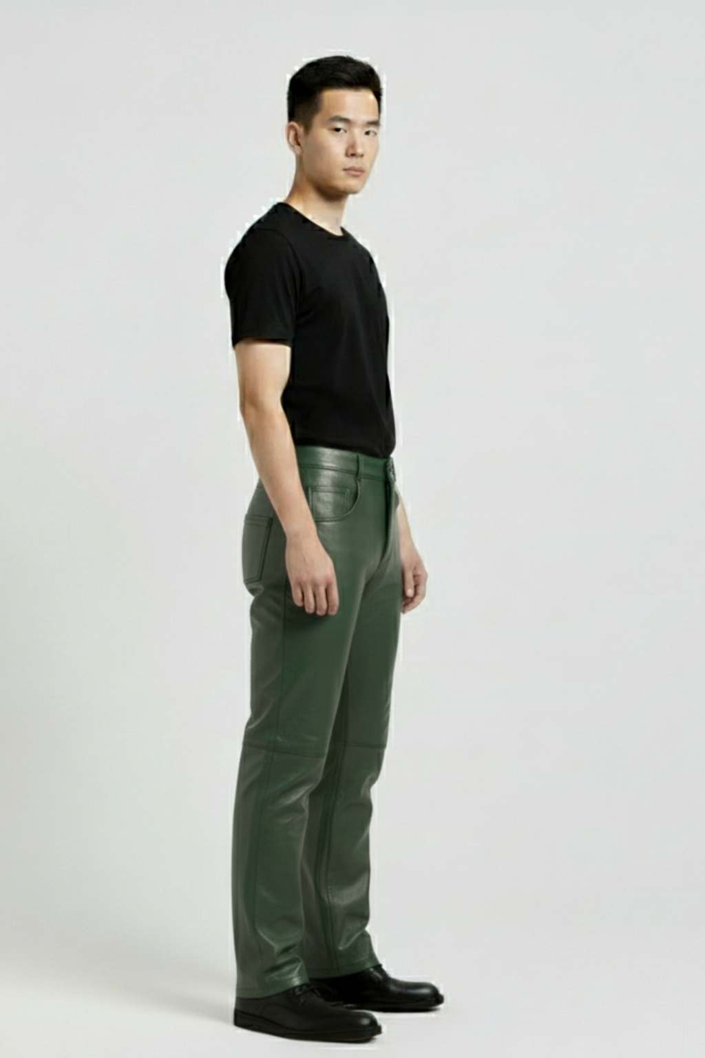 Side profile of Maverick Finnian forest green leather pants showing knee seam construction and straight leg fit. Maverick Jacket.