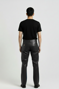 Rear view of male model wearing Maverick Tristan black leather cargo pants showing fitted seat silhouette and rear pocket styling. Maverick Jacket.
