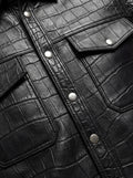 Macro shot of crocodile-embossed leather texture and silver snap button detail on shirt. The Damien by Maverick Jacket.