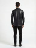 Rear view of male model wearing Maverick Damien croc-embossed leather shirt showing tailored shoulder fit and curved hem styling. Maverick Jacket.