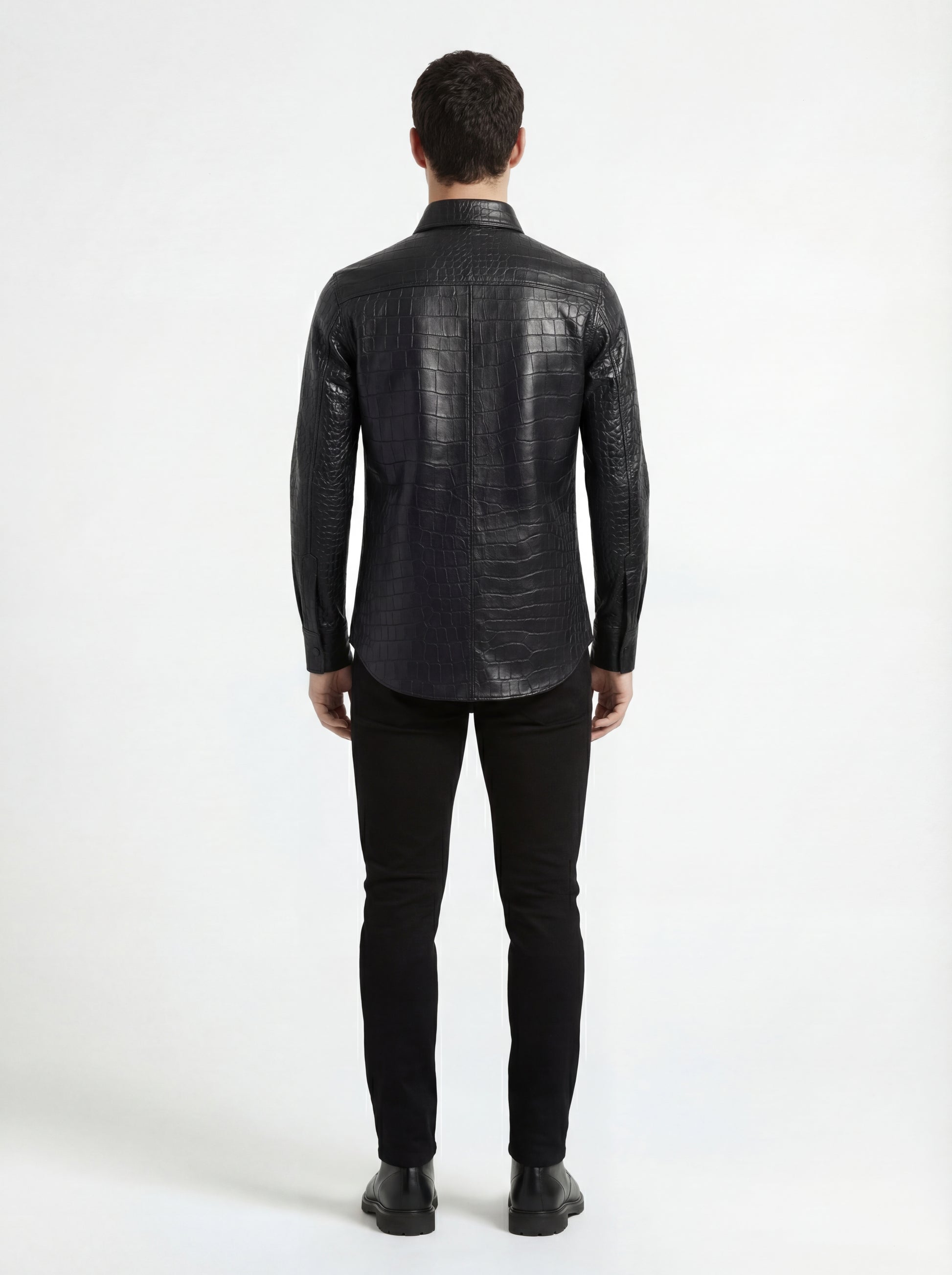 Rear view of male model wearing Maverick Damien croc-embossed leather shirt showing tailored shoulder fit and curved hem styling. Maverick Jacket.