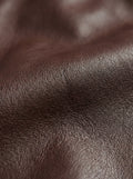 Macro shot of grained black leather texture and chest flap pocket stitching on zip-front shirt. The Elliot by Maverick Jacket.