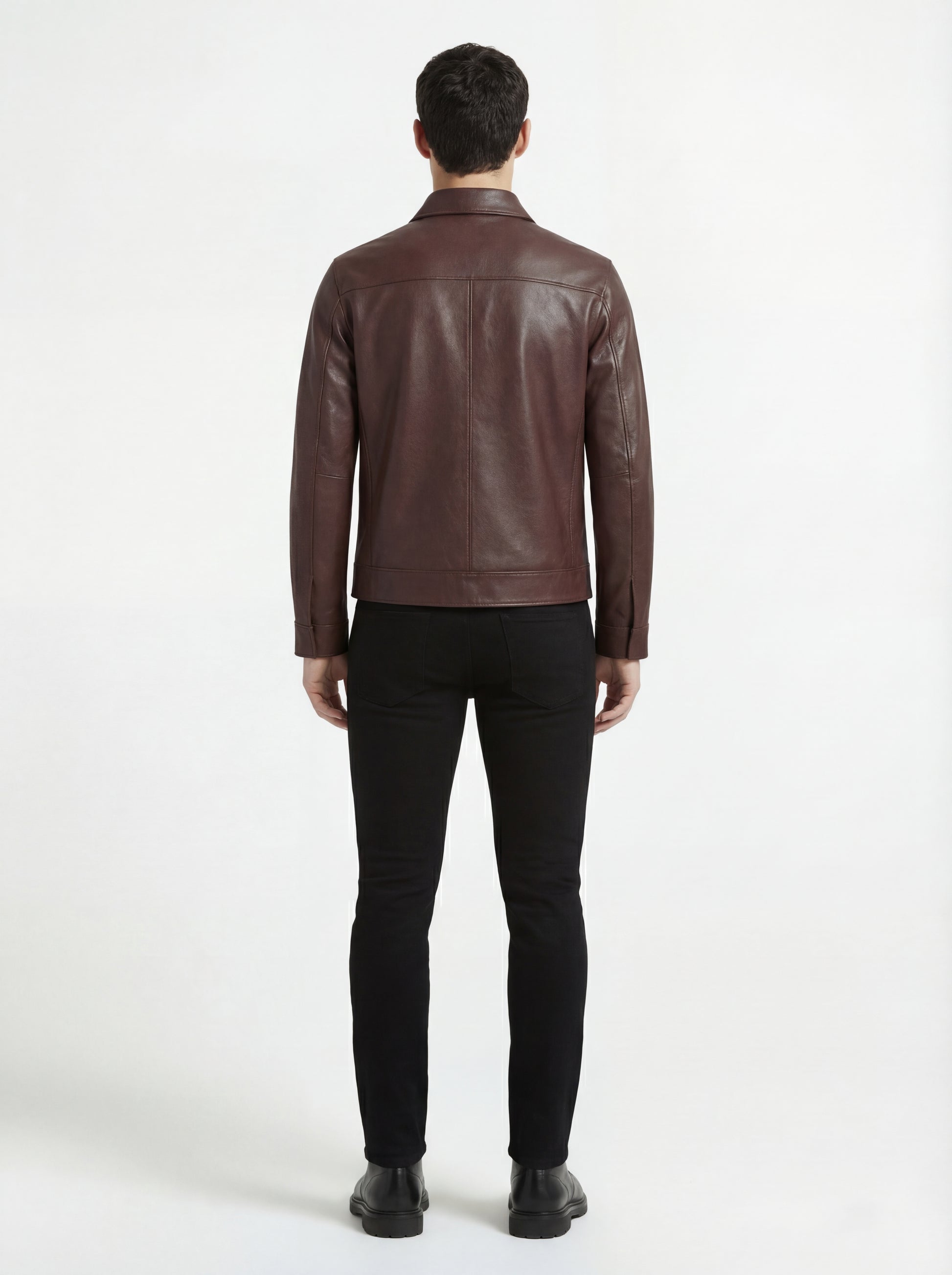 Rear view of male model wearing Maverick Elliot leather zip-front shirt showing tailored shoulder fit and straight hem styling. Maverick Jacket.