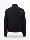Rear view of black suede bomber jacket showing clean back paneling and ribbed hem. The Soren by Maverick Jacket.