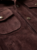 Macro shot of soft brown suede texture and fringe strand detailing on jacket. The Boone by Maverick Jacket.