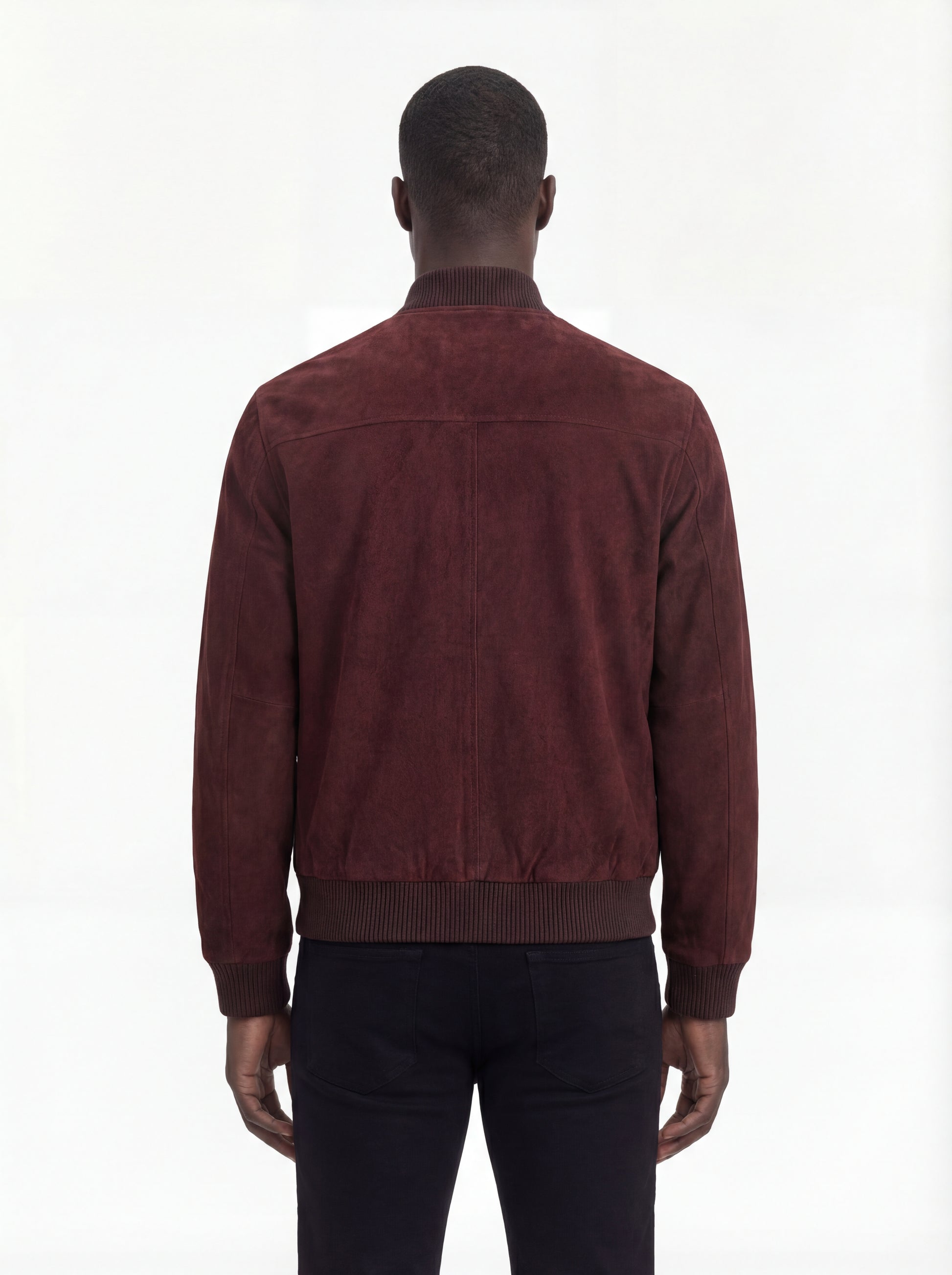 Rear view of male model wearing Maverick Miles suede bomber jacket showing broad shoulder fit and ribbed waist styling. Maverick Jacket.