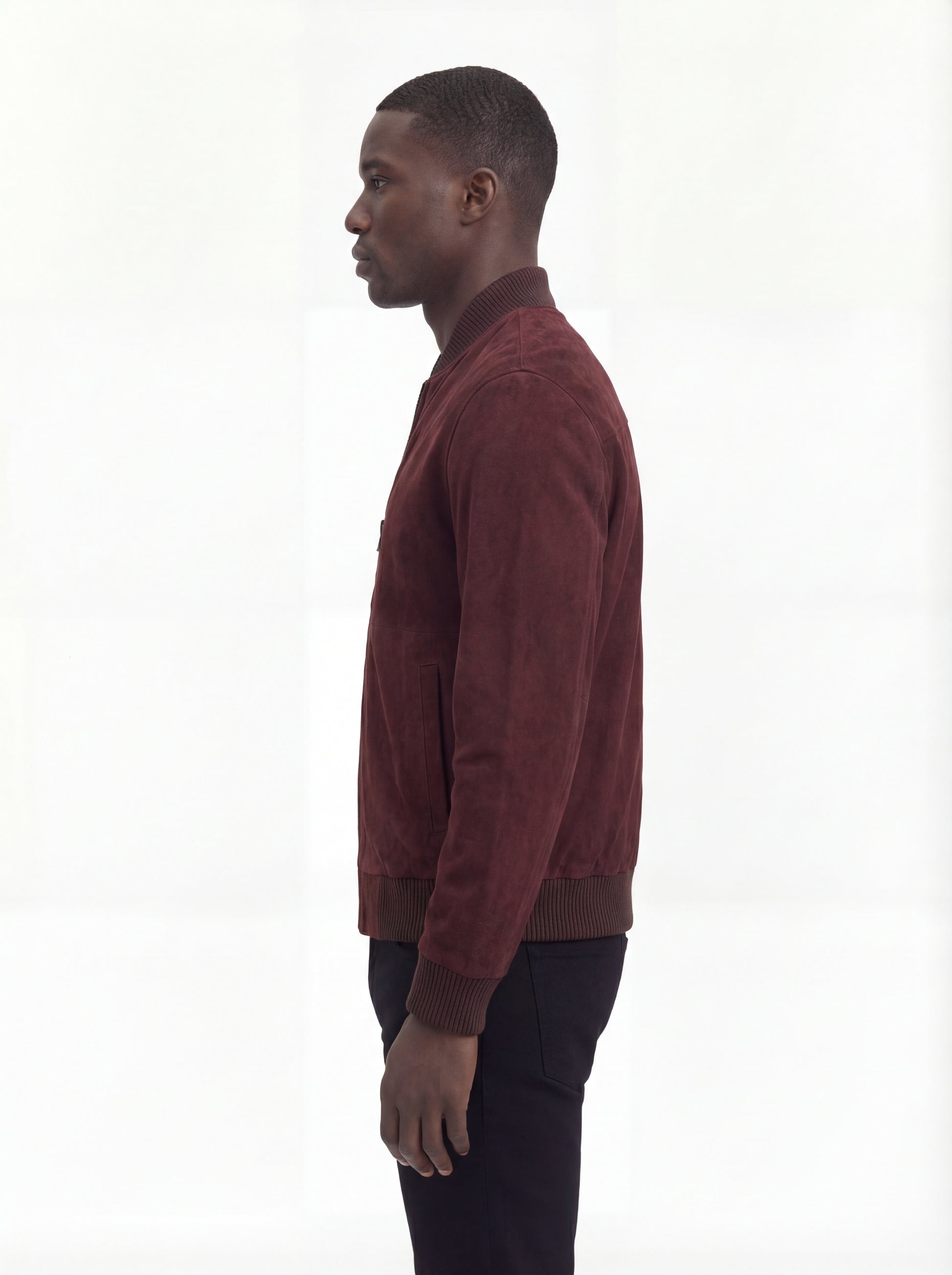 Side profile of Maverick Miles suede bomber jacket showing ribbed sleeve cuffs and classic bomber silhouette. Maverick Jacket.