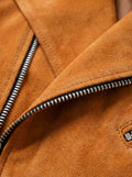 Macro shot of soft orange suede texture and silver zipper hardware on biker jacket. The Dylan by Maverick Jacket.