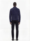 Rear view of male model wearing Maverick August suede trucker jacket showing tailored shoulder fit and clean back paneling. Maverick Jacket.