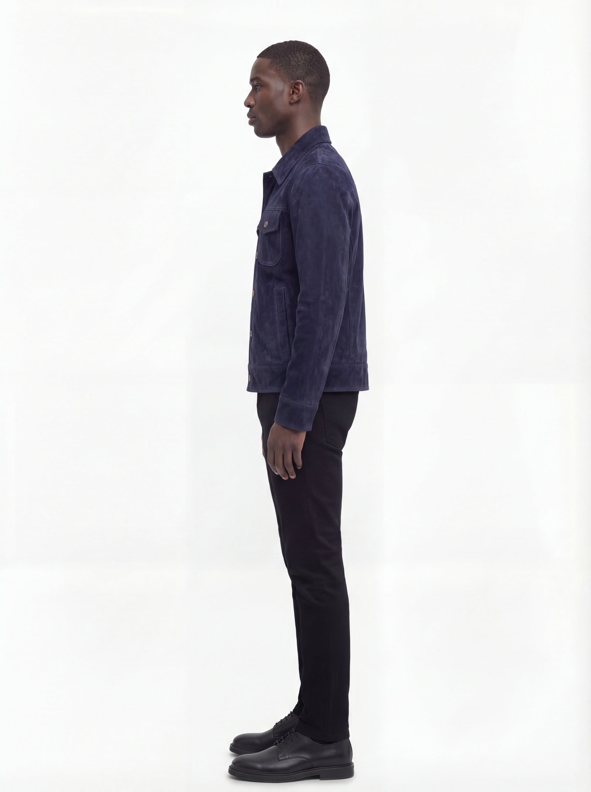 Side profile of Maverick August suede trucker jacket showing sleeve cuff structure and straight torso silhouette. Maverick Jacket.