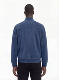 Rear view of male model wearing Maverick Jude suede bomber jacket showing broad shoulder fit and ribbed waist styling. Maverick Jacket.