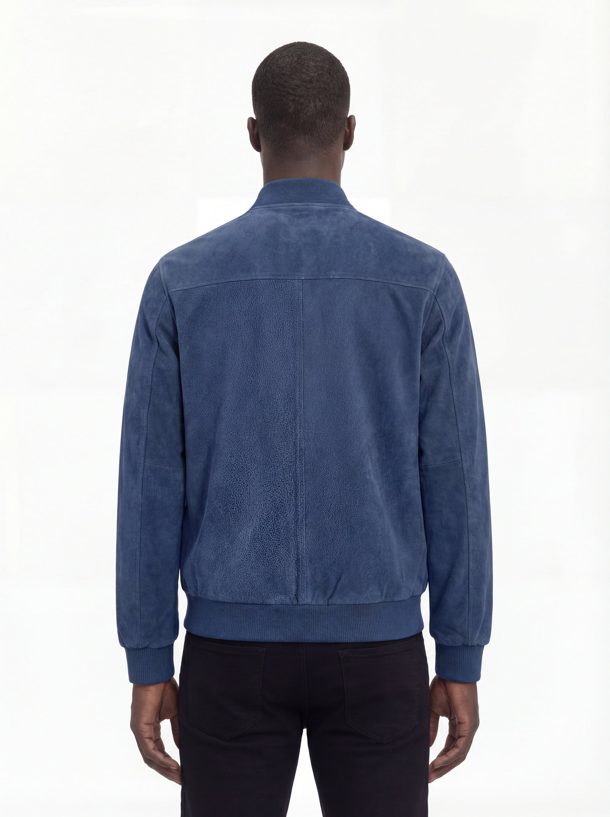 Rear view of male model wearing Maverick Jude suede bomber jacket showing broad shoulder fit and ribbed waist styling. Maverick Jacket.