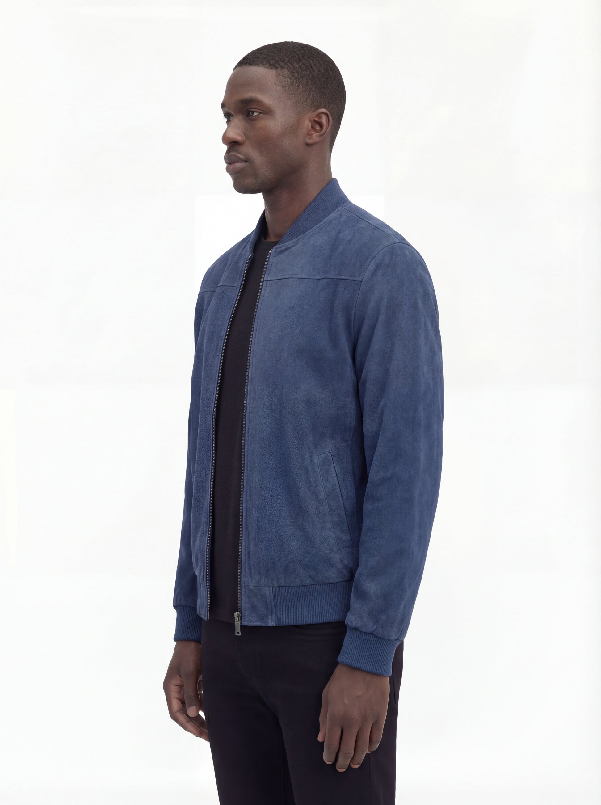 Side profile of Maverick Jude suede bomber jacket showing ribbed sleeve cuffs and classic bomber silhouette. Maverick Jacket.
