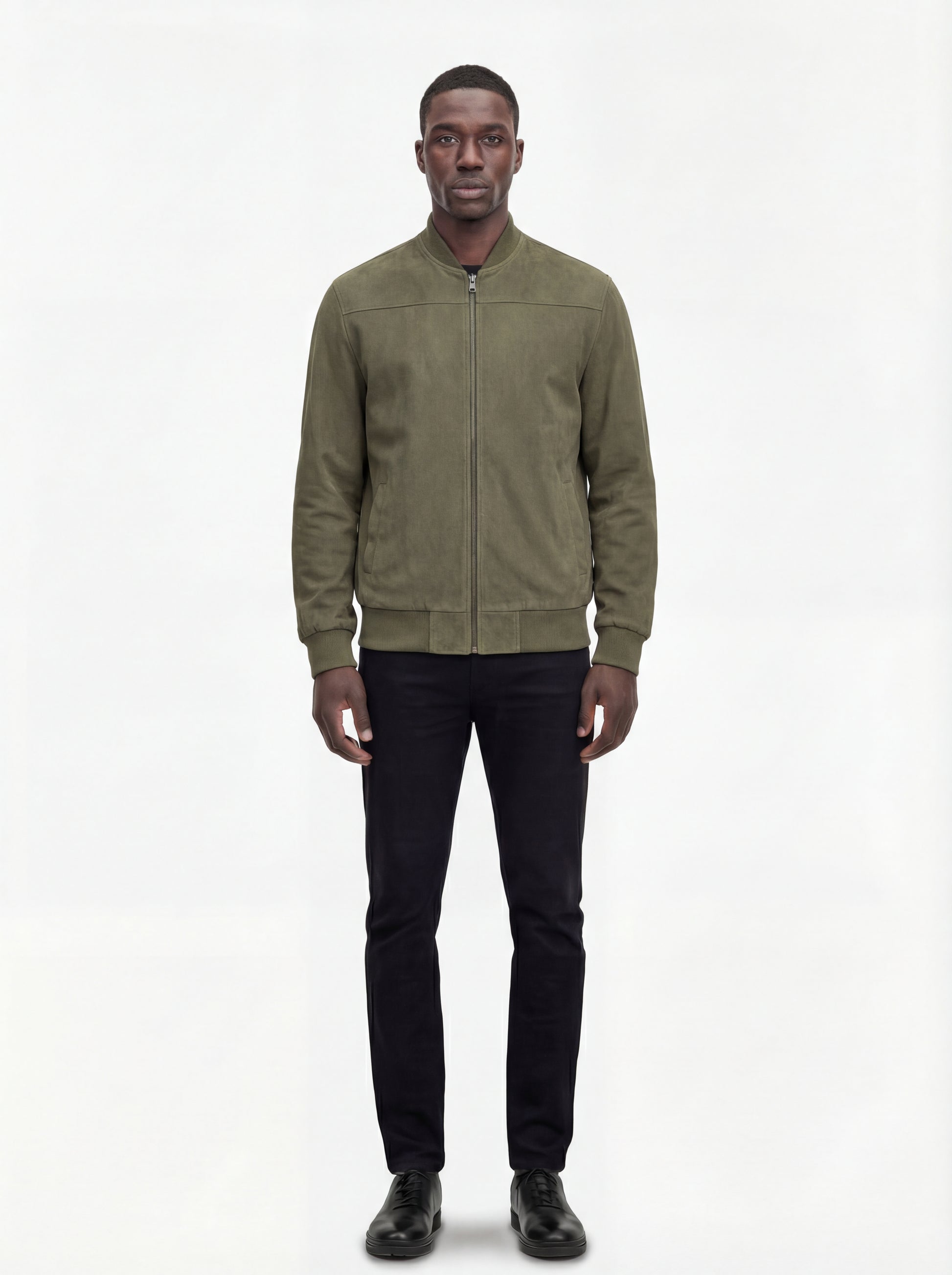 Male model wearing Maverick Evan suede bomber jacket, regular fit, styled with black jeans. Maverick Jacket.