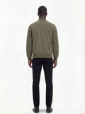 Rear view of male model wearing Maverick Evan suede bomber jacket showing broad shoulder fit and ribbed waist styling. Maverick Jacket.