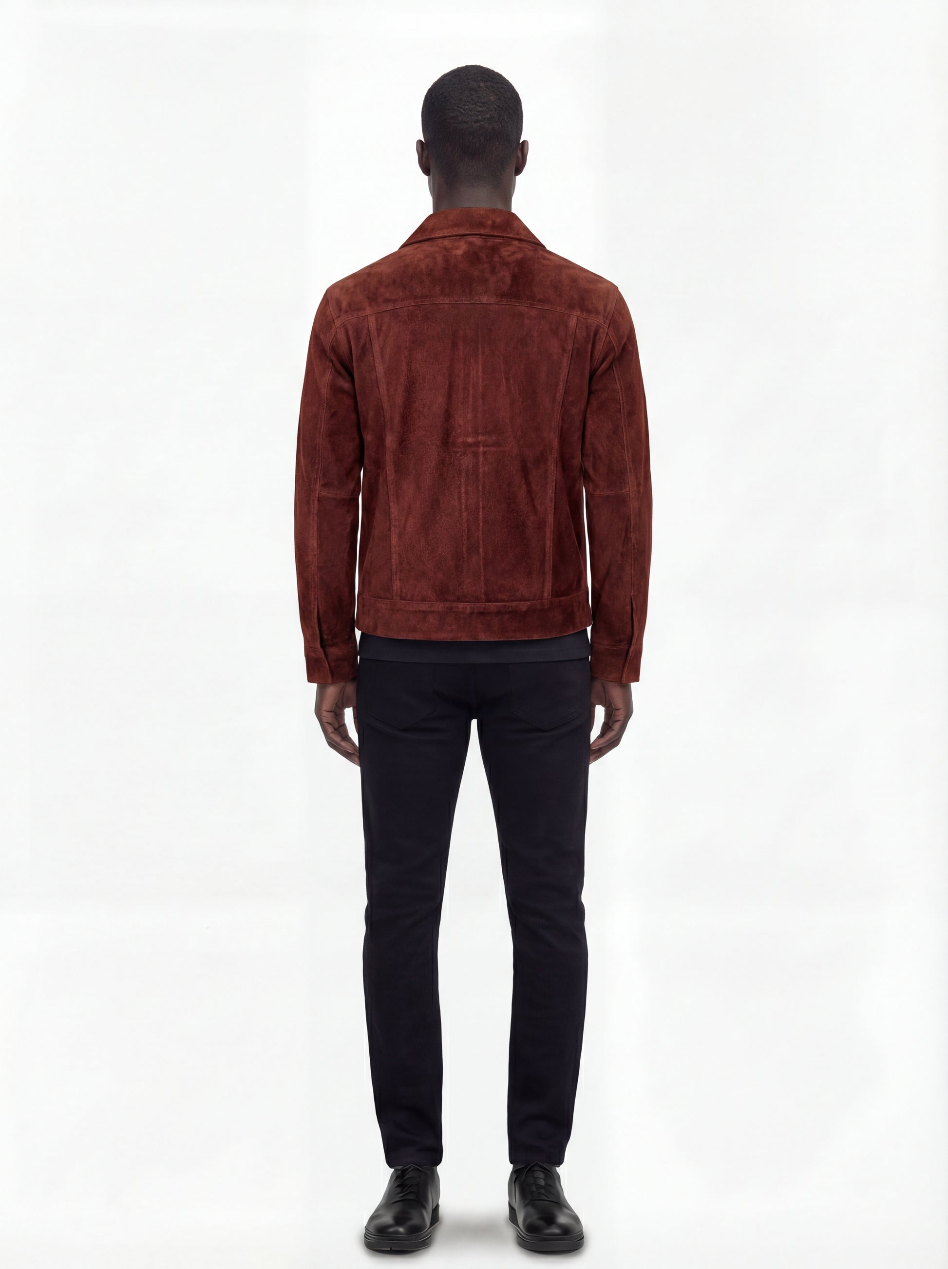 Rear view of male model wearing Maverick Rowan suede trucker jacket showing tailored shoulder fit and clean back paneling. Maverick Jacket.