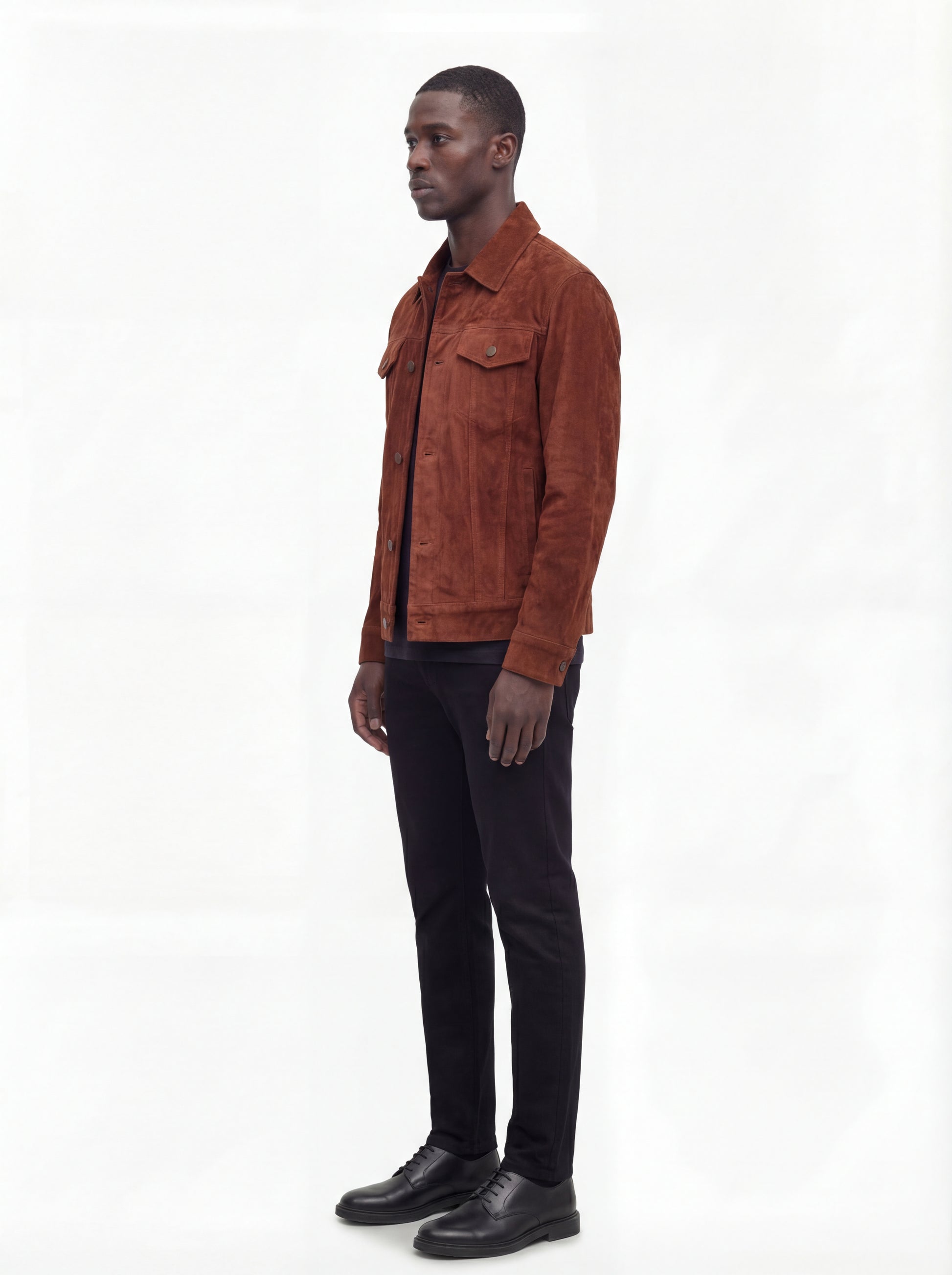 Side profile of Maverick Rowan suede trucker jacket showing sleeve cuff structure and straight torso silhouette. Maverick Jacket.