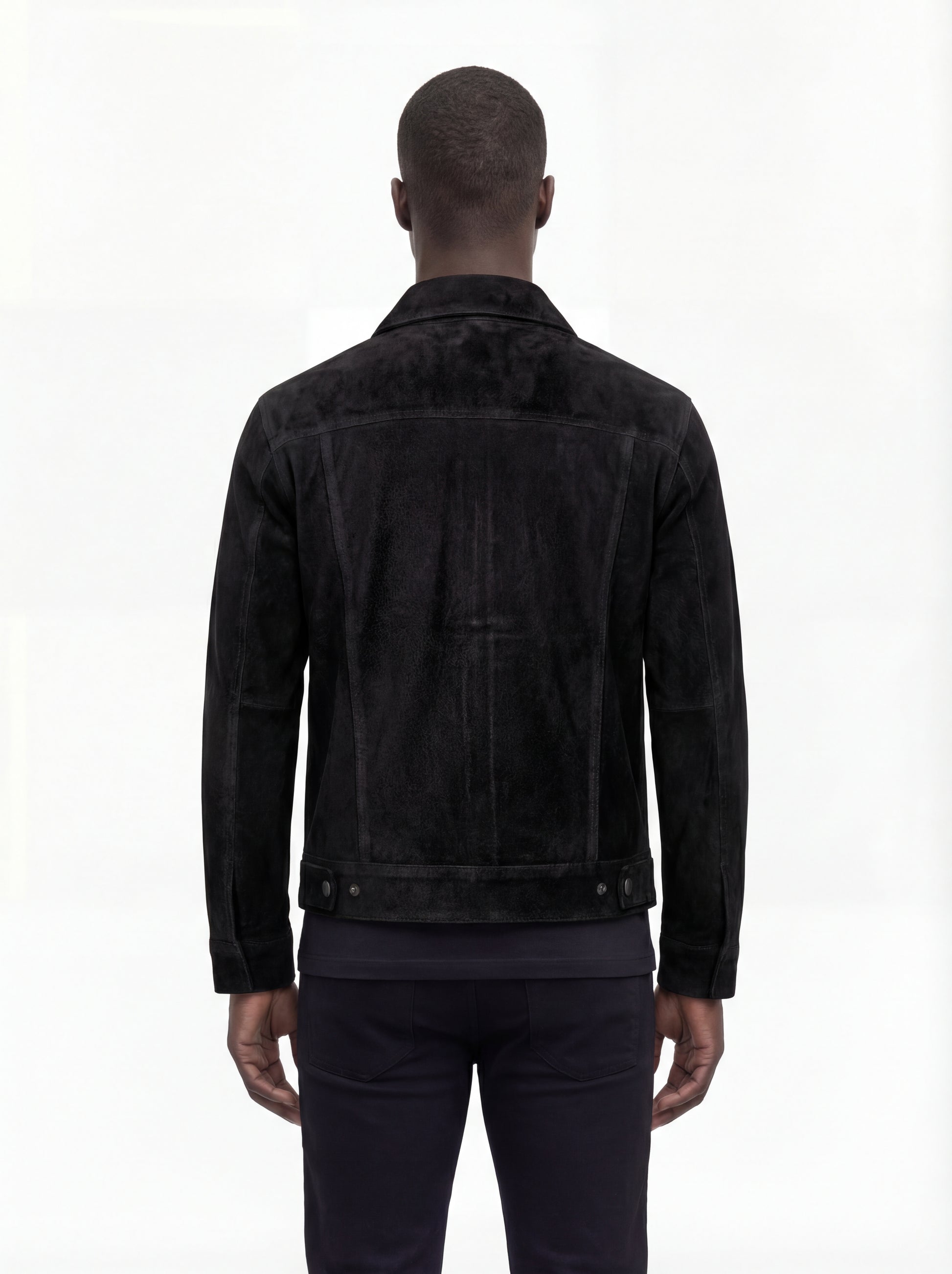 Rear view of male model wearing Maverick Lennon suede trucker jacket showing tailored shoulder fit and clean back paneling. Maverick Jacket.