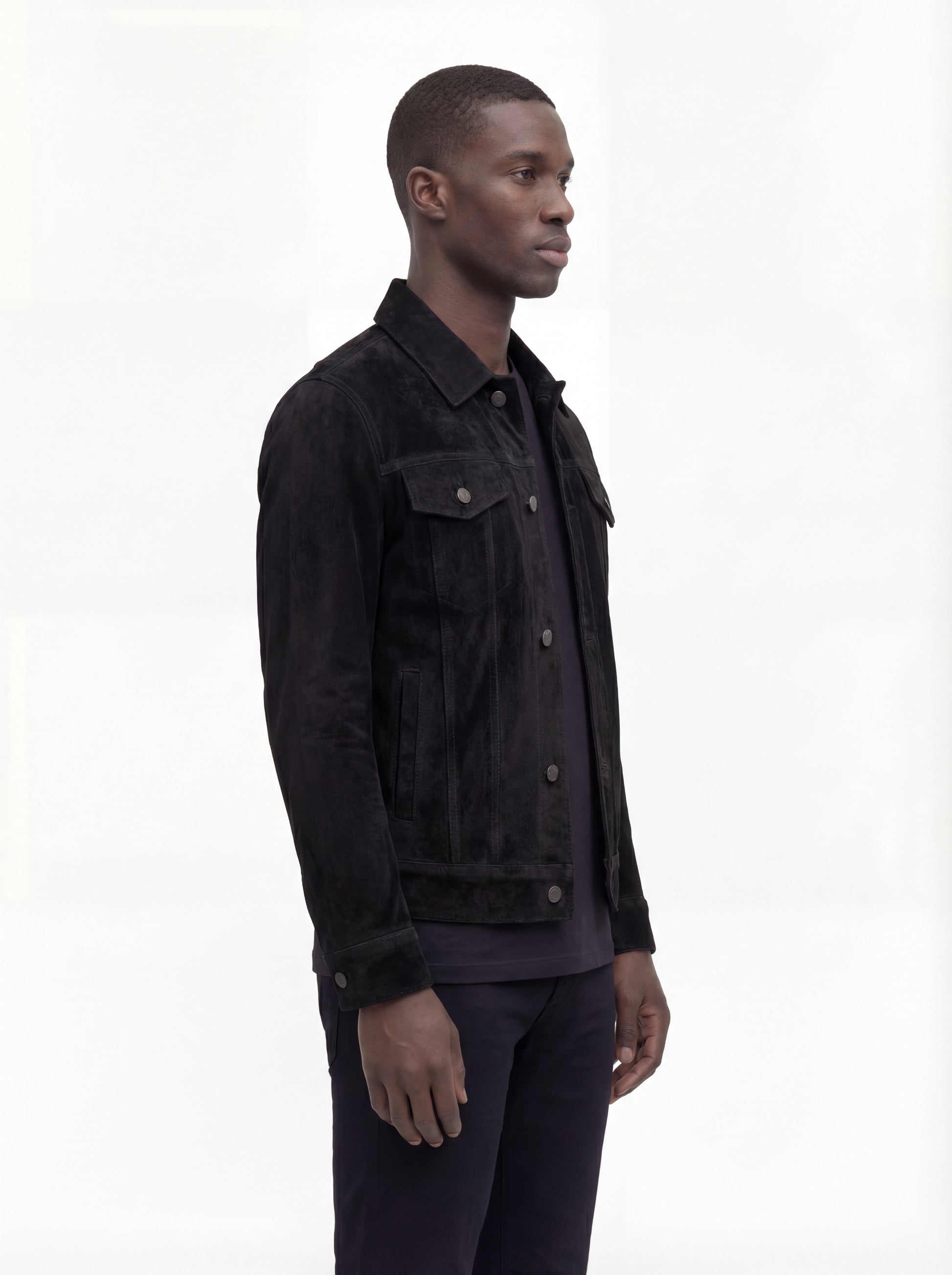 Side profile of Maverick Lennon suede trucker jacket showing sleeve cuff structure and straight torso silhouette. Maverick Jacket.
