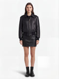 Female model wearing Maverick Isla leather bomber jacket, relaxed fit, styled with Maverick Orla black leather mini skirt. Maverick Jacket.