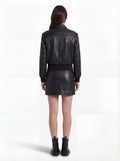 Rear view of female model wearing Maverick Isla leather bomber jacket showing structured shoulder fit and elasticated hem styling. Maverick Jacket.