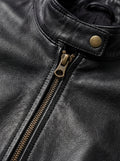 Macro shot of pebbled black leather texture and brass zipper puller on café racer jacket. The Maeve by Maverick Jacket.