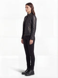 Side profile of Maverick Maeve café racer jacket showing fitted sleeve structure and hip-length silhouette. Maverick Jacket.