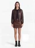 Female model wearing Maverick Isla leather bomber jacket, relaxed fit, styled with Maverick Orla brown leather mini skirt. Maverick Jacket.