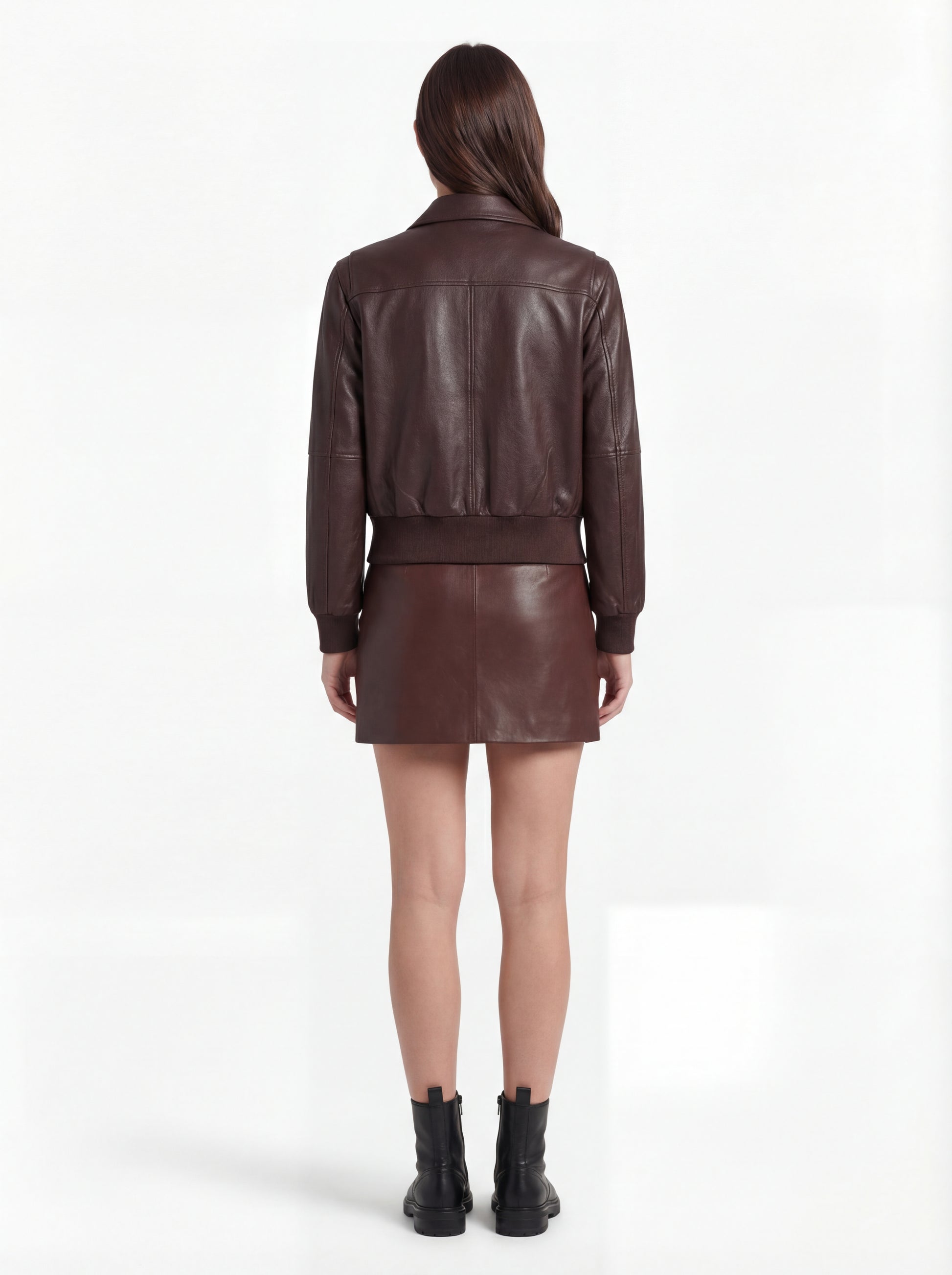 Rear view of female model wearing Maverick Isla leather bomber jacket showing structured shoulder fit and elasticated hem styling. Maverick Jacket.