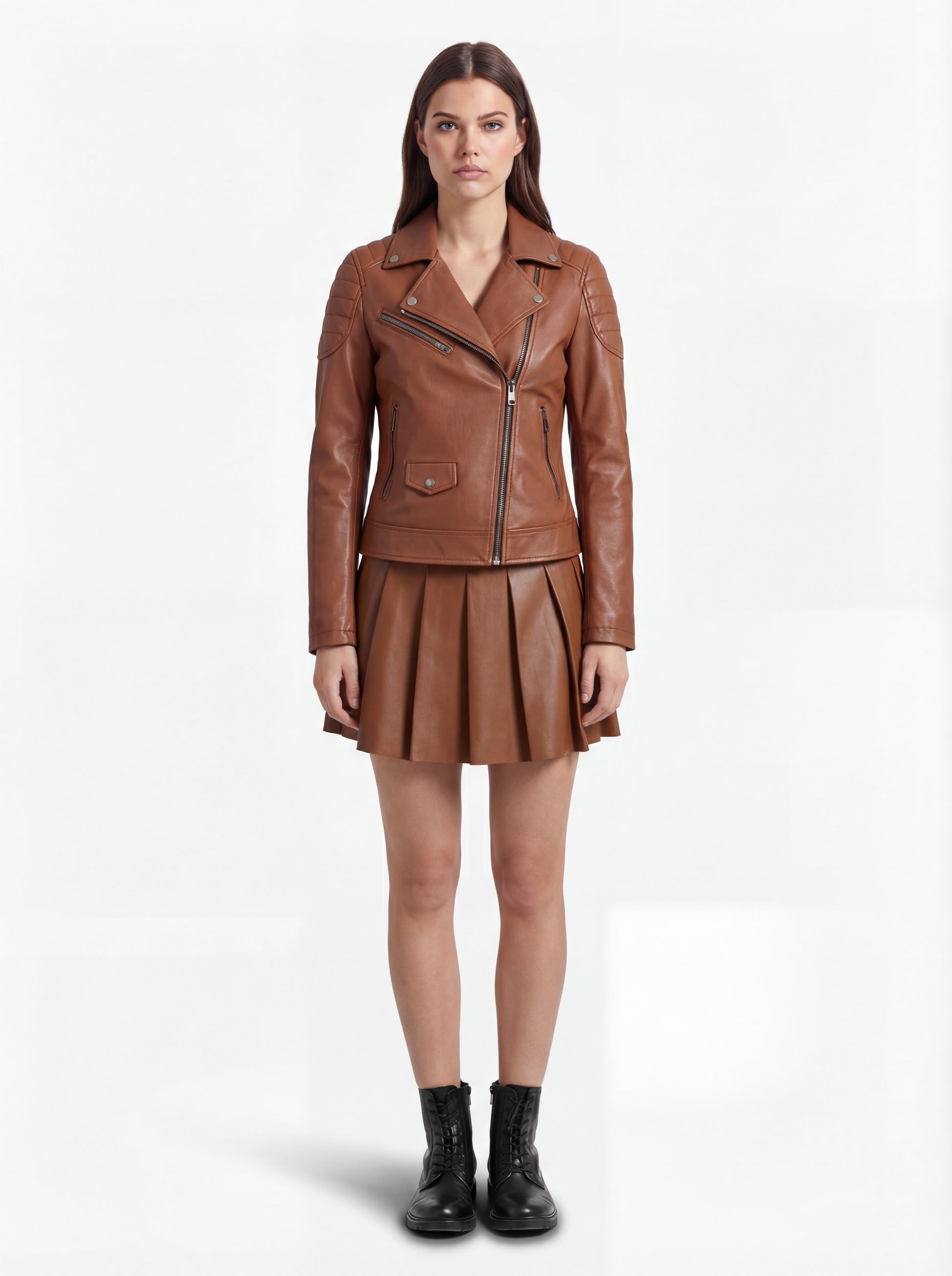 Female model wearing Maverick Stella leather biker jacket, slim fit, styled with Maverick Poppy tan pleated leather skirt. Maverick Jacket.