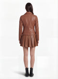 Rear view of female model wearing Maverick Stella leather biker jacket showing structured shoulder fit and quilted panel construction. Maverick Jacket.