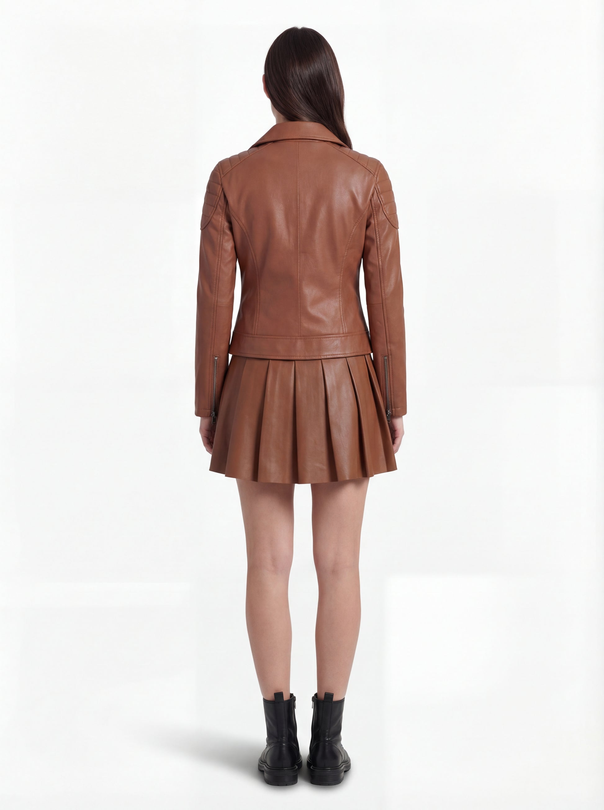 Rear view of female model wearing Maverick Stella leather biker jacket showing structured shoulder fit and quilted panel construction. Maverick Jacket.