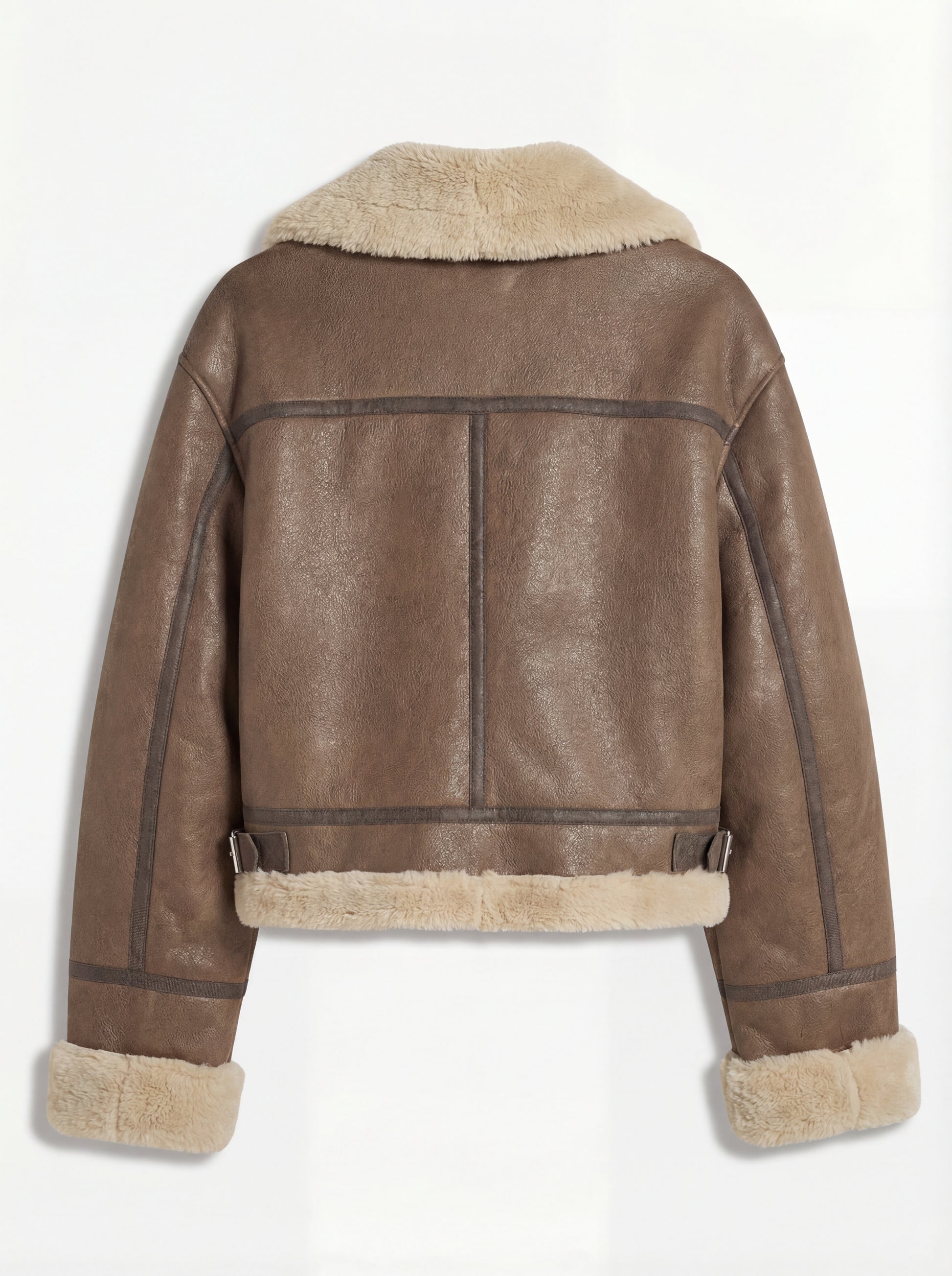 Rear view of brown leather shearling aviator jacket showing vertical center seam and adjustable side waist buckles. The Amelia by Maverick Jacket.
