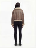 Rear view of female model wearing Maverick Amelia aviator jacket showing structured shoulder fit and fur-lined hem. Maverick Jacket.