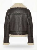 Rear view of black leather aviator jacket showing vertical center seam and cream shearling hem. The Thea by Maverick Jacket.