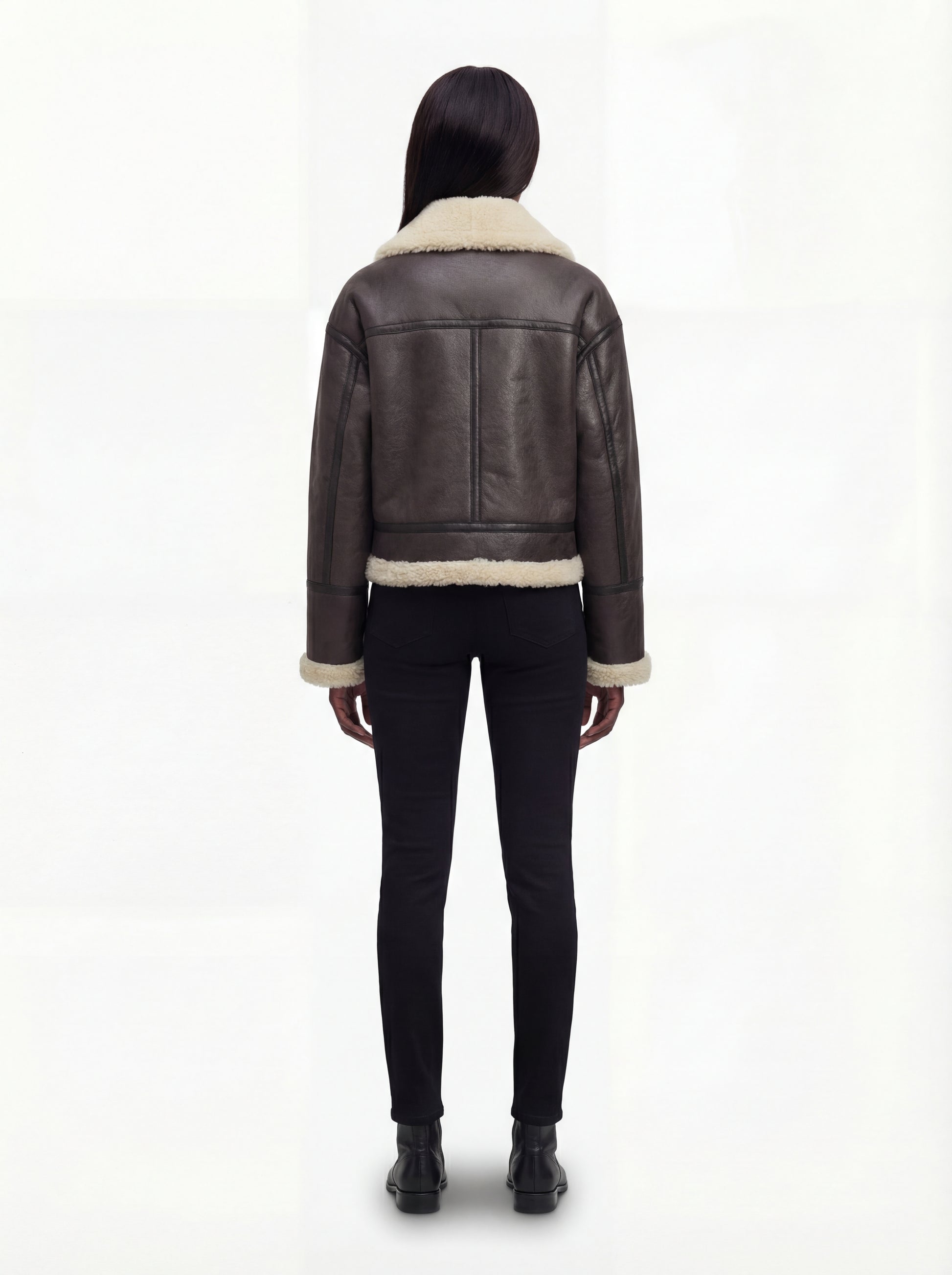 Rear view of female model wearing Maverick Thea aviator jacket showing structured shoulder fit and clean back paneling. Maverick Jacket.