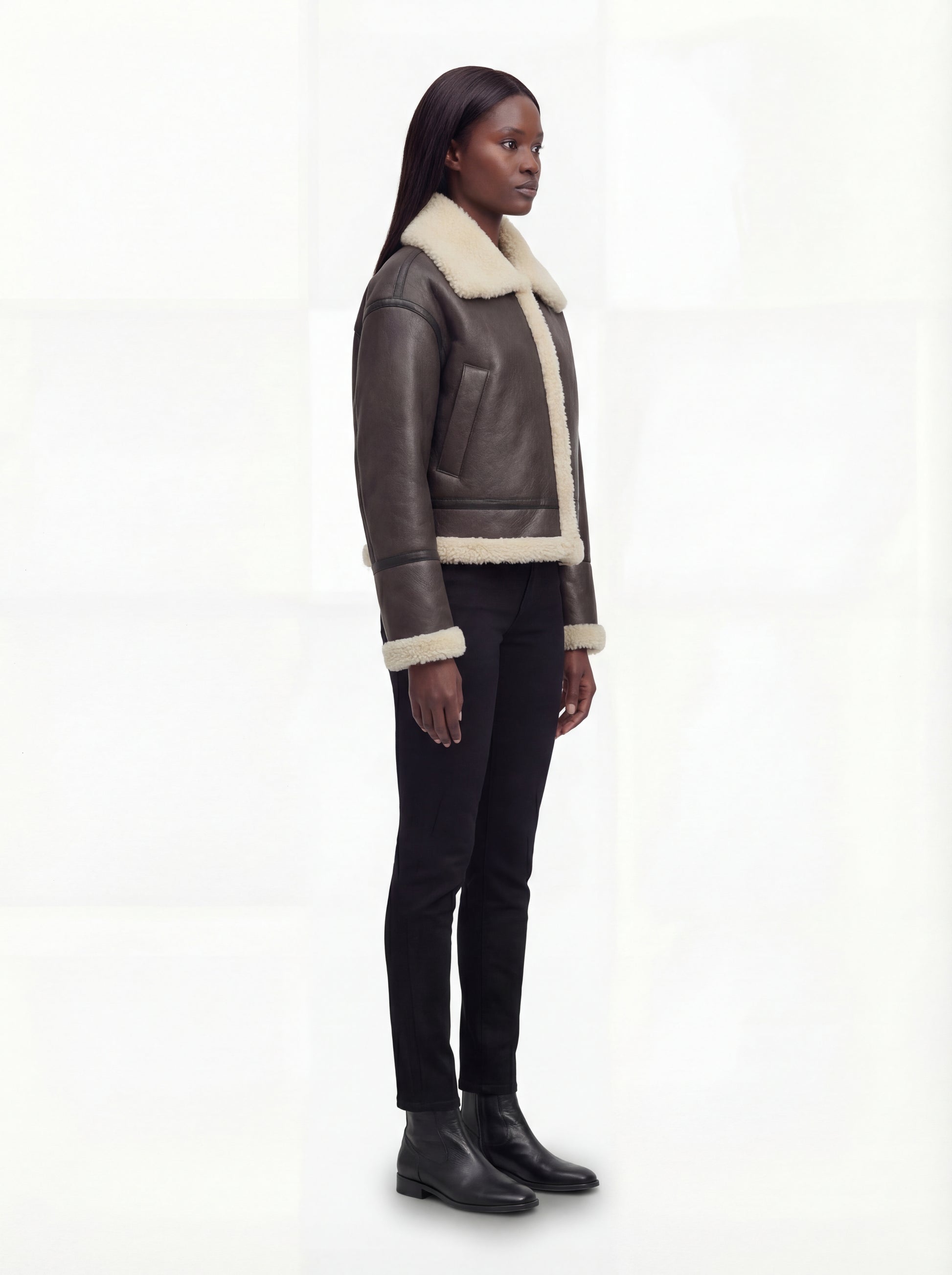 Side profile of Maverick Thea aviator jacket showing leather sleeve length and boxy silhouette. Maverick Jacket.