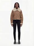Female model wearing Maverick Anya shearling aviator jacket, relaxed fit, styled with black skinny jeans and black leather boots. Maverick Anya.