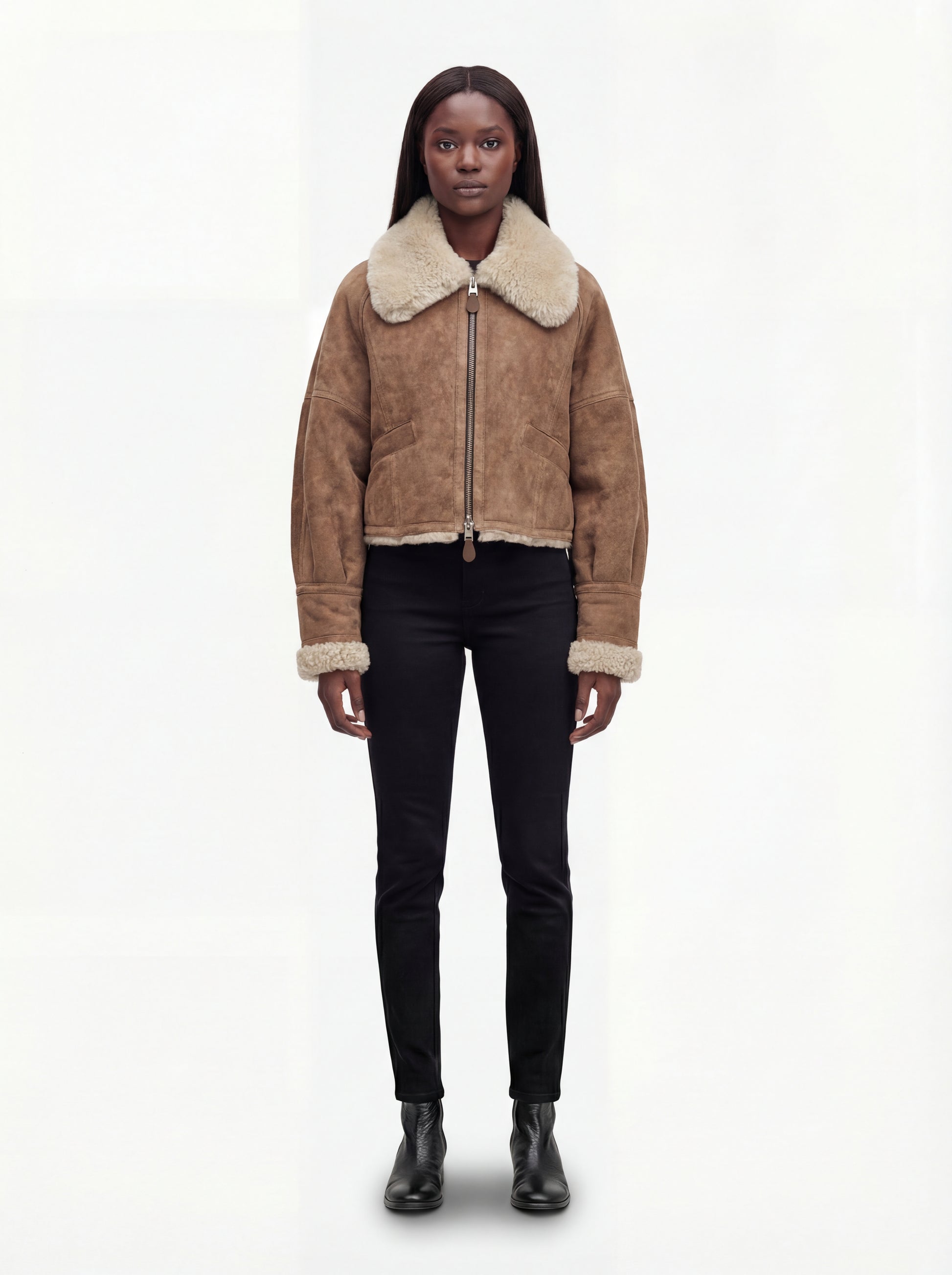 Female model wearing Maverick Anya shearling aviator jacket, relaxed fit, styled with black skinny jeans and black leather boots. Maverick Anya.