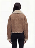 Rear view of female model wearing Maverick Anya shearling aviator jacket showing dropped shoulders and cream shearling hem trim. Maverick Anya.