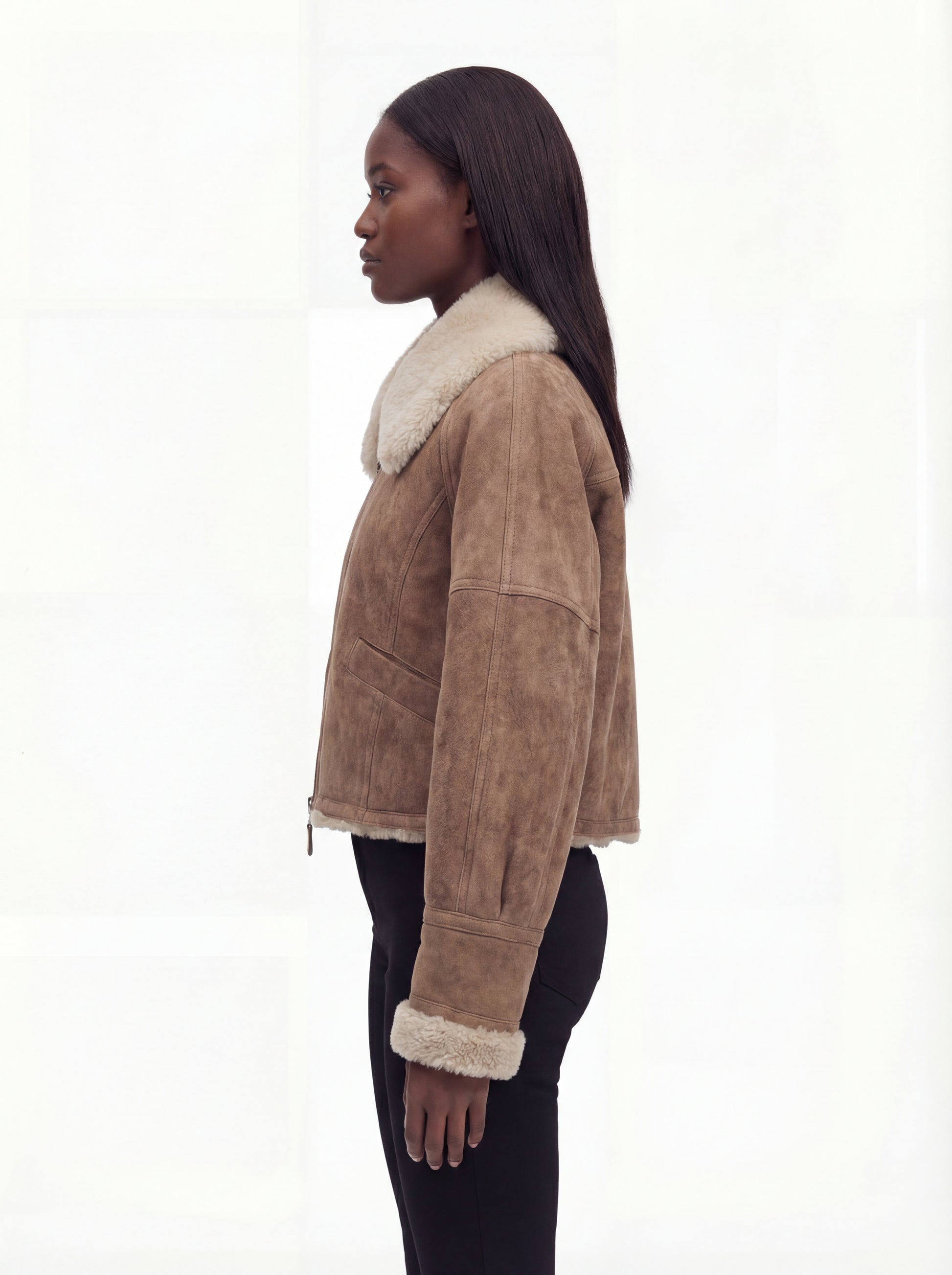 Side profile of Maverick Anya aviator jacket showing shearling cuff detail and boxy hip-length silhouette. Maverick Anya.